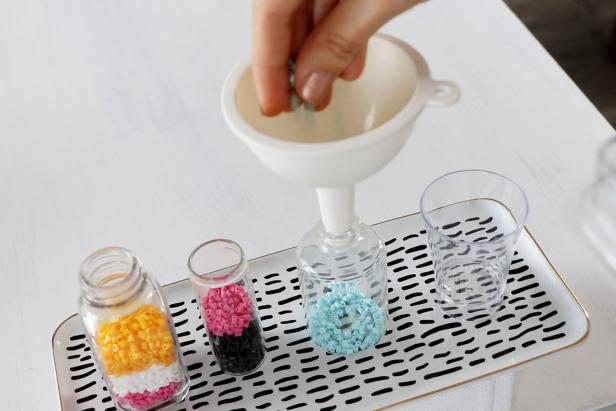 Fill up your clear containers with mini Perler Beads. Use a funnel if your containers have a small opening.