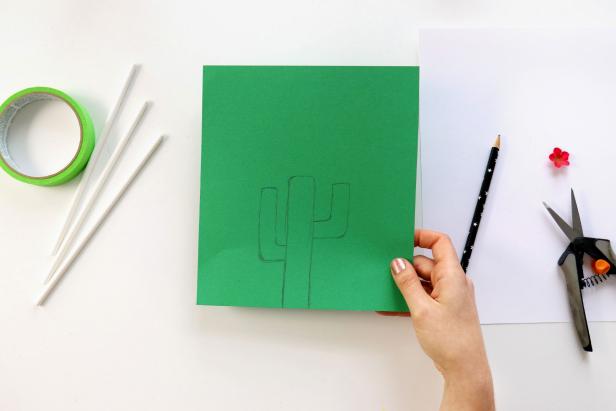 Begin by drawing a cactus shape on green paper and cut out.
