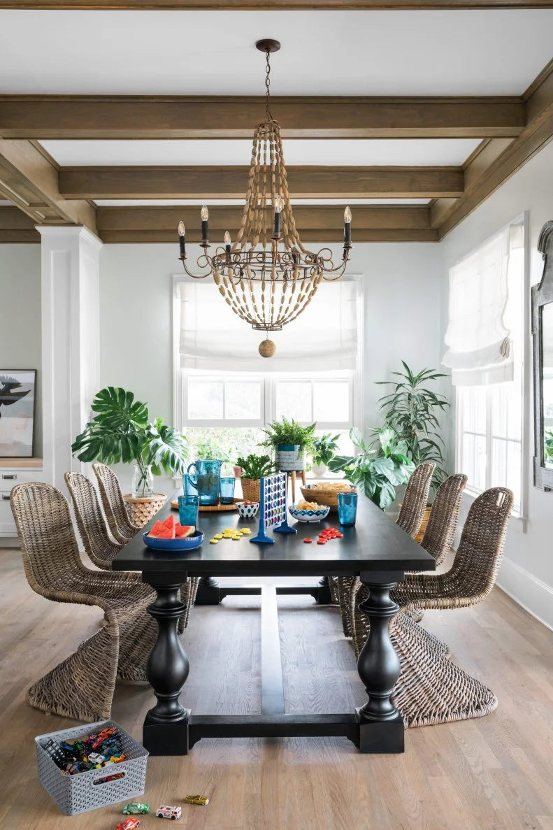 If you're looking to only design your kitchen and dining area once, try and stick with the classics whenever possible. Just steps from the kitchen island is the family command center which involves homework, checking email, gathering for meals and playing games. The key design element here is the ebony farmhouse table which is sturdy, timeless and extremely versatile, so much that it can be paired with virtually any style lighting or seating and work seamlessly. 