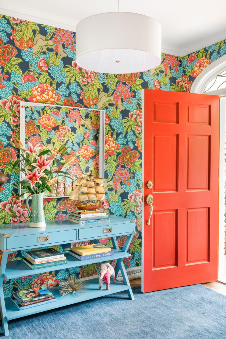 From the moment you enter the Monteiths' home, you're introduced to bright and happy colors. The bold red of the front door is echoed in the colors of the entryway wallpaper, and the blues from the wallpaper make their way down onto a campaign style console table and a medium blue area rug.