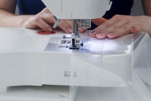 Use a sewing machine to sew a rectangle into a page protector, leaving the top open. Cut it out, leaving a small border around your stitches.