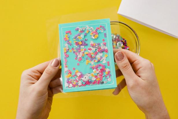Use this same method to make a notebook by sewing one side of a page protector to folded scrapbook paper. Fill with confetti and sew closed. Cut and fold paper to fit inside and staple your notebook together