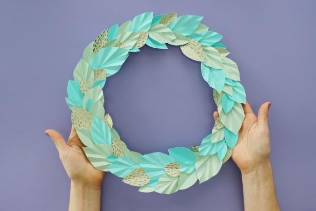 Use hot glue to glue your leaves all the way around the wreath.