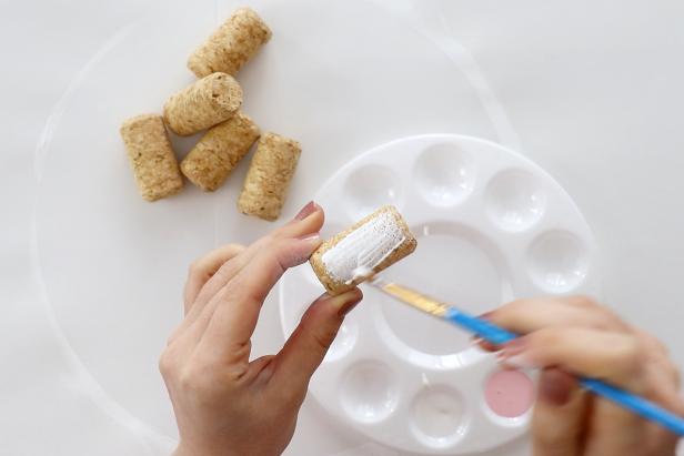 Paint your corks. We painted ours with pink, white, and gray acrylic paint.