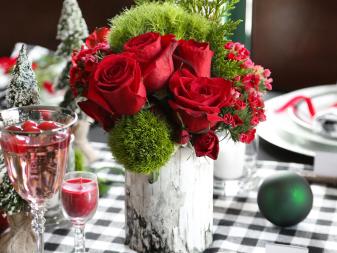Birch bark-covered containers filled with mosses and rich red flowers add an elegant yet woodsy touch to this holiday table.  Create your own woodland vases by covering upcycled coffee cans with pieces of birch bark, or even birch printed scrapbooking paper if real birch bark is not available! Simple adhere the bark to the coffee can using hot glue.