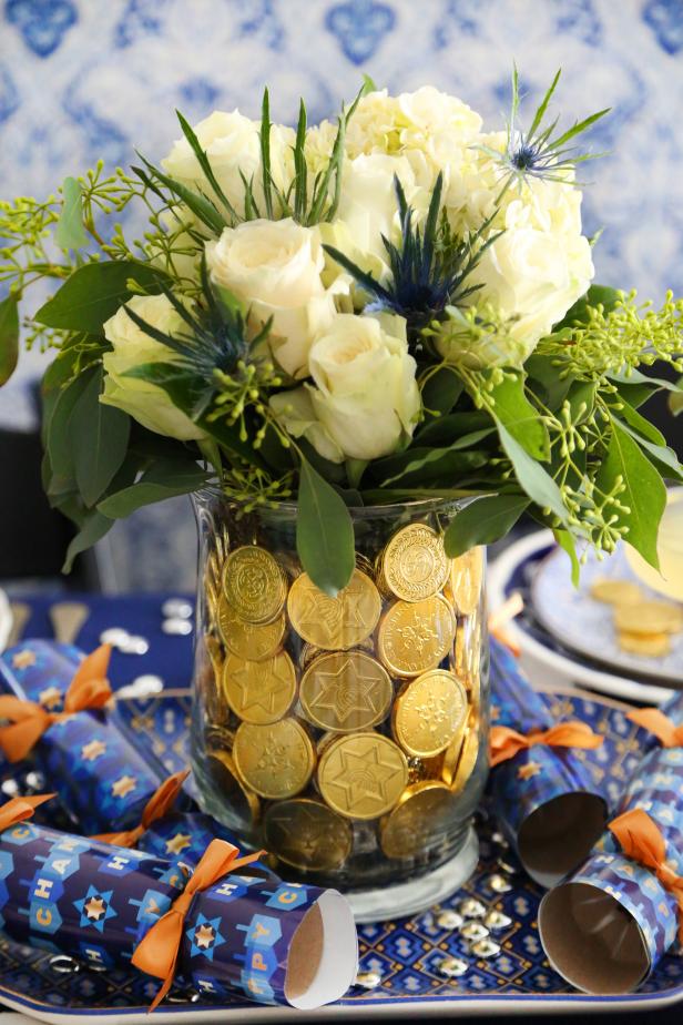 Glowing Gelt Hanukkah Centerpiece If you’re looking for a unique decoration for your Hanukkah celebration, then look no further. These gelt embellished floral arrangements will look elegant on your holiday table. They’re simple to craft using nesting vases and plenty of gold chocolate coins.
