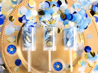 Confetti poppers are an exciting addition to a Hanukkah table setting. They’re a colorful, effervescent way of celebrating, and pretty enough to use as table decor. 
