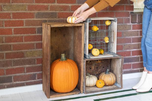 A Vertical Display of Vintage Crates With Fall Gourds