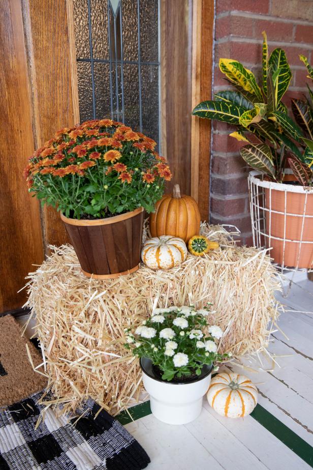 Straw Bale Surrounded by Fall Decor on Porch