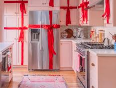 It's rainbow in the living room, but pink and red in Kelly's gasp-worthy kitchen. Carrying on her mom's tradition, Kelly's taken to wrapping her cabinets like Christmas presents each year with ribbon she gets at her local craft store (it's easier to pull off than you'd expect).