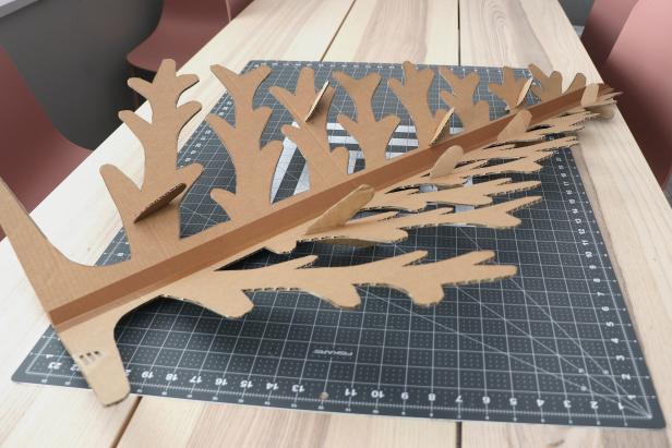 Place your branches where you want them to go. Mark the inside and the bottom of the V and cut a slit for the branch to slide into. Repeat this on all of the tree pieces.