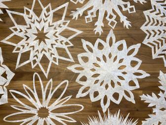Paper snowflakes made out of coffee filters on wood countertop