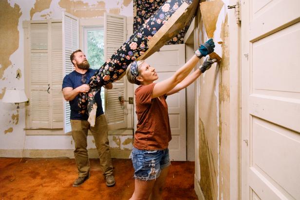 As seen on Home Town, Ben and Erin Napier work together to remove wallpaper from the Simoneau house, which will be completely renovated.