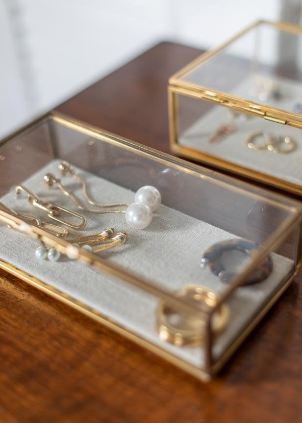 Glass and brass boxes provide a pretty way to display jewelry on a tabletop.