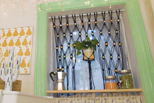 Beaded Boho Curtain Hangs in Window With Potted Plant in Middle