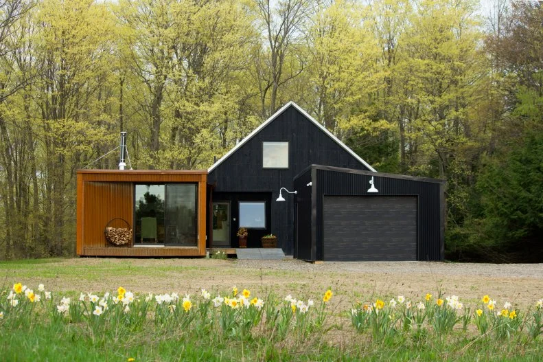 Longtime small house advocate Sheri Koones' new book Downsize: Living Large in a Small House offers interior and exterior images of 33 houses that tell the story of the various reasons homeowners decide to go small: empty-nesters, retirees and people simply ready to simplify and make their lives more budget-friendly are some of the justifications for downsizing.

A case in point, at just 1,436 square feet (all houses in the book are 2,000 square feet or less), this Corning, New York home was built as a forever home for a retiring arts administrator who chose an open-plan, one-level design to better help her with a goal of aging in place.