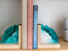 Resin Bookends Flanking Three Books on Floating Shelf