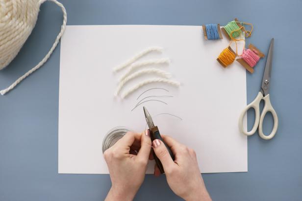 Cut four pieces of thick white yarn and four pieces of wire. Insert each piece of wire into a piece of yarn. This is what will help the rainbow keep its shape.