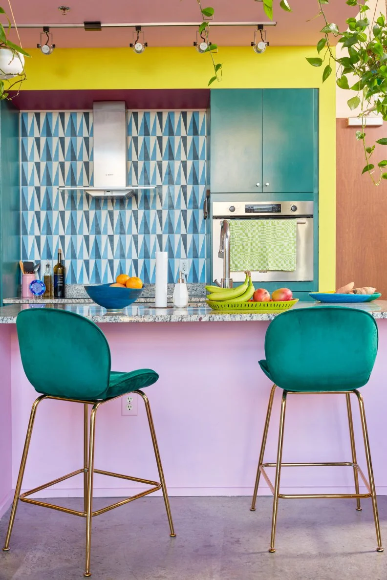 Like the dining room, the kitchen claims its own colorways identity with its embrace of deep, emerald green. Michelle reveals that, “Since the condo is a very open concept, we had to do the work of making sure that the palettes of the different rooms played well together. They’re each distinct, but they make sense cohesively.”