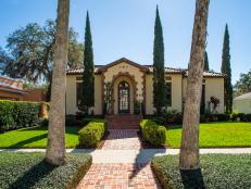 Landscaped Front Yard at Stucco Villa With Arched Brick Facade