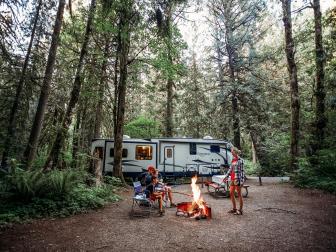 A family relaxing with an RV at a campground