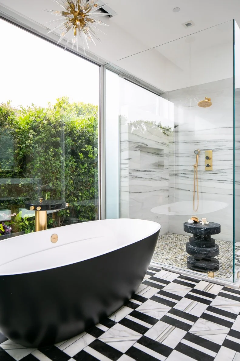 Modern Bathroom Features a Black Tub and a Marble Walk-In Shower