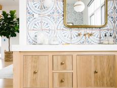 Patterned Wall Tiles, Marble Floors, Brass Mirror and Hardware Vanity