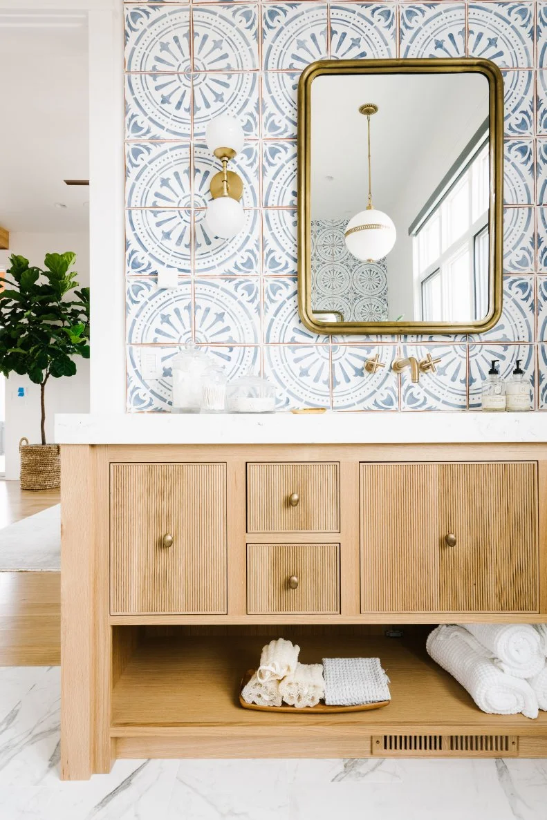 Patterned Wall Tiles, Marble Floors, Brass Mirror and Hardware Vanity