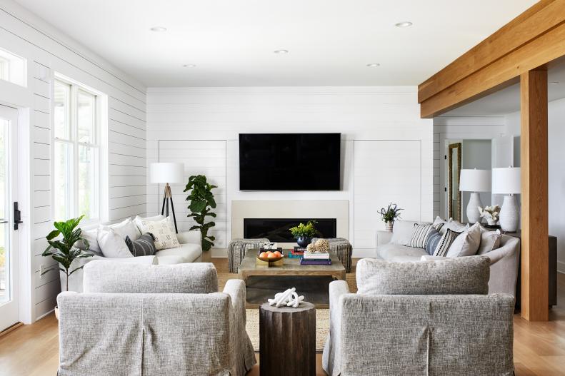 Neutral Living Room Features a Built-In Fireplace and Shiplap Walls