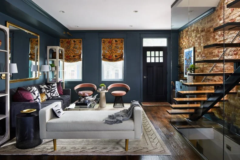 Dark Foyer With Glass Enclosed Stairs, Sofa, Front Door, Two Windows