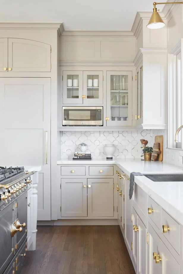 Kitchen With Brass Pulls, Hardware, Lights Throughout, Island Cooktop