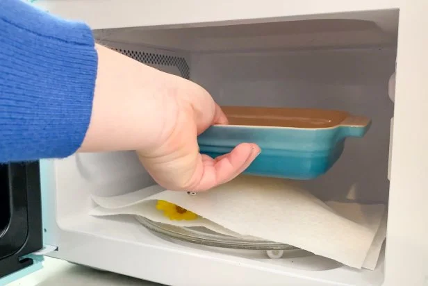 Place them inside the microwave and add weight by adding a microwave-safe casserole dish on top. Make sure all the flowers are under the weight.