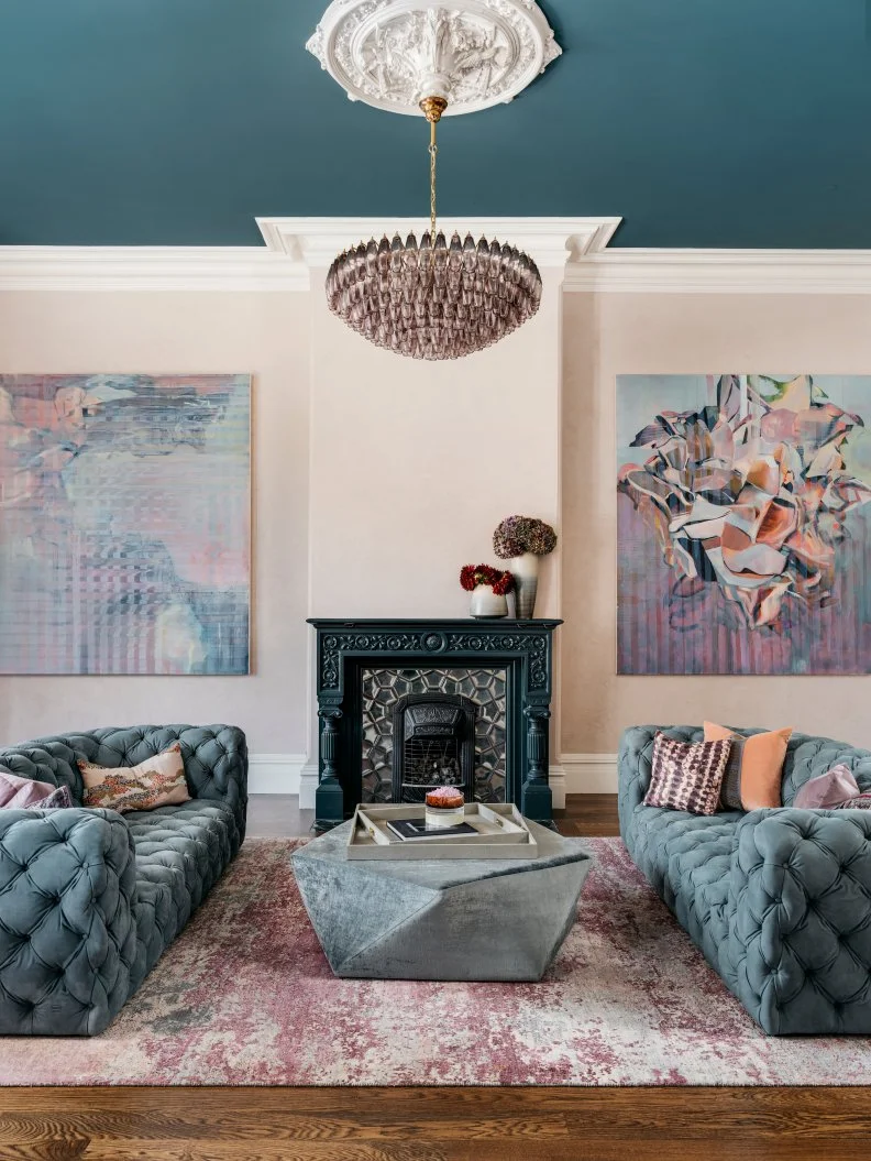 Sitting Room Features an Ornate Fireplace and Matching Sofas