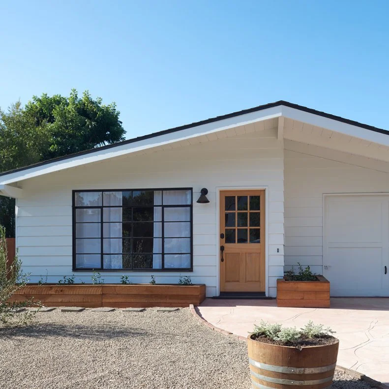 Pebble and Paver Drive at Coastal Modern Tiny Home With Large Window