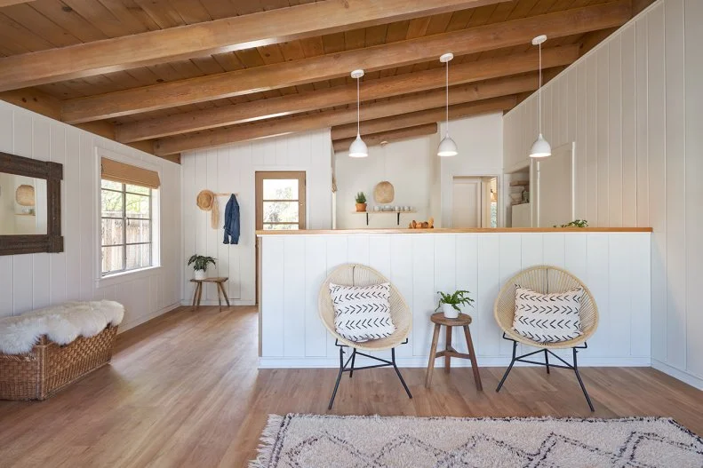 Living Area With Exposed Beam Ceiling, Two Woven Seats, Three Pendants