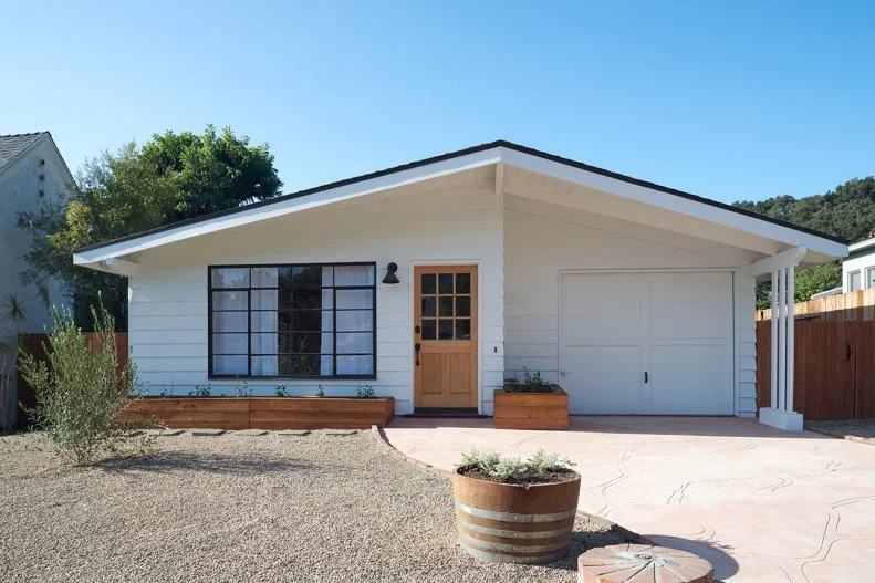 Black-And-White Exterior on Updated Coastal Retreat, Paver Driveway