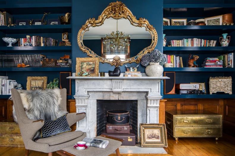 Living Room Features a Marble Fireplace and Built-In Bookshelves