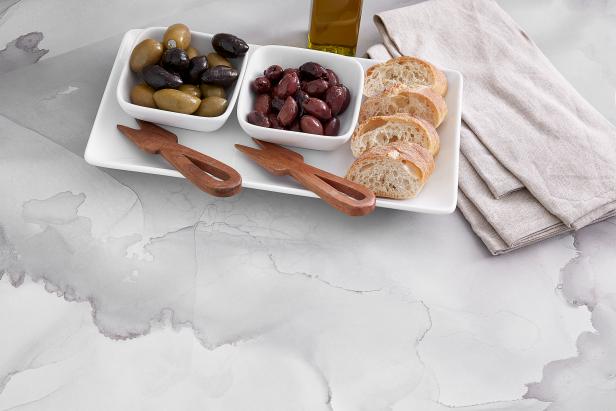 Appetizers on a white and gray watercolor-patterned countertop.
