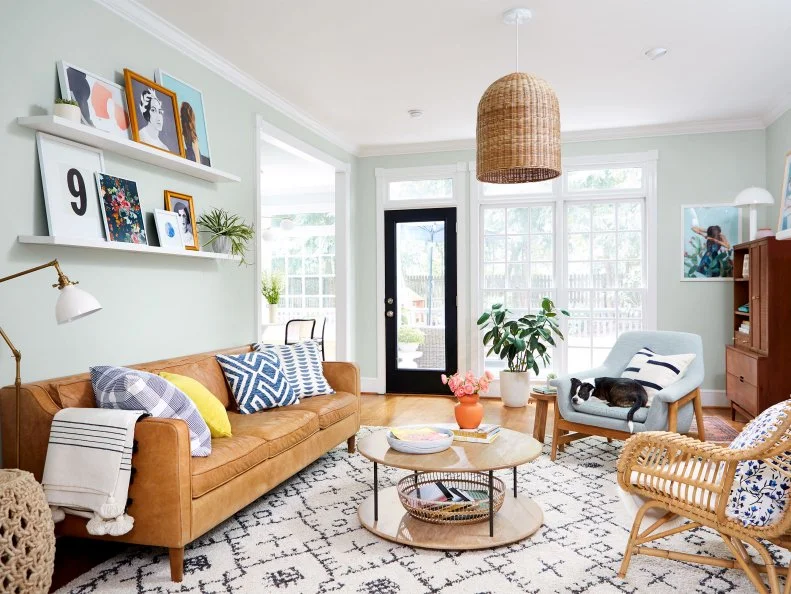 Adding texture makes a space more interesting, and Erin layered it on. She traded in the old ceiling fan for a woven pendant and complemented it with a rattan chair (both by Serena & Lily). The tone of the leather sofa picks up on the legs of the plush armchair (both are from West Elm). The supersoft rug is from Boutique Rugs.