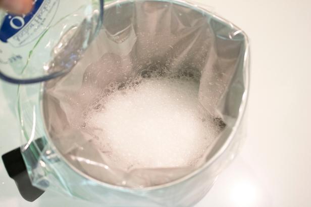 Baking soda and vinegar interacting in a container.