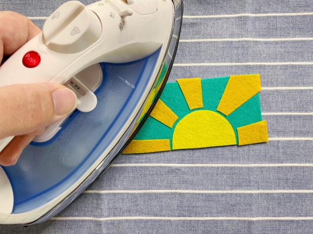 Peel off the adhesive backing of each piece. Then recreate and assemble the patch you designed. Iron together by carefully pressing the iron on to the patch, lift and repeat. Do not slide or your design will shift. Tip: Irim and adjust design as needed.
