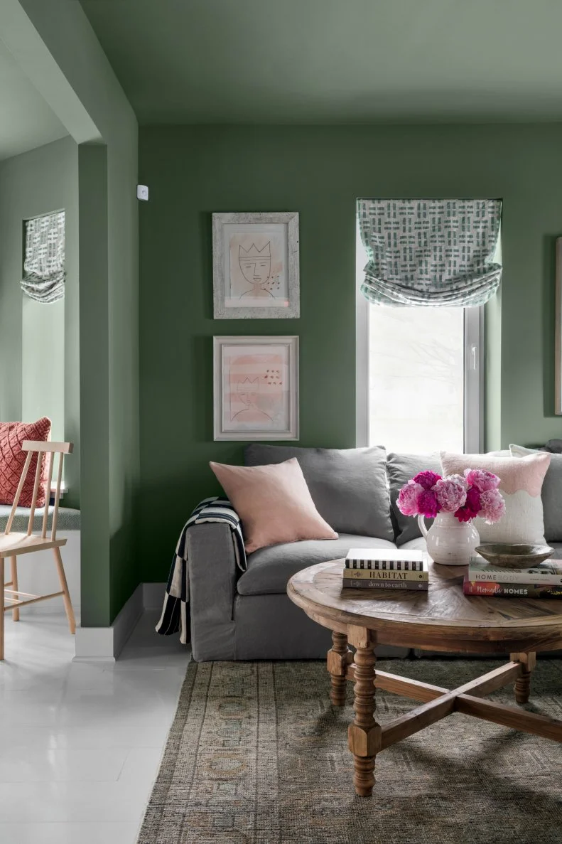 Green Living Room Sitting Area Features Round Coffee Table