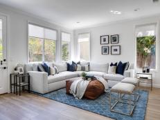 White sectional and blue area rug.