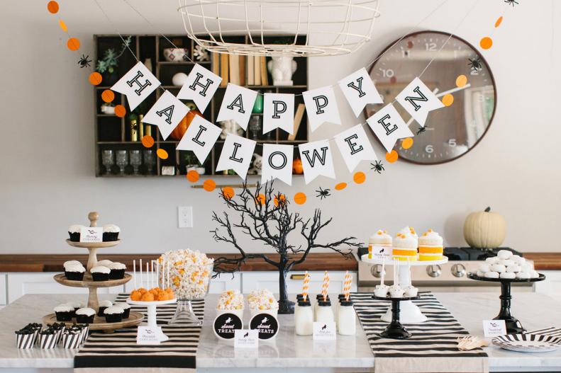 Start with neutral decor like black and white party basics, cake stands and table runners, then add pops of color here and there. Wood, burlap and linen always work beautifully for fall celebrations, too.