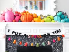 That black cobwebby pattern surrounding the fireplace is actually peel-and-stick wallpaper. Kailo Chic's Kara Whitten paired it with colorfully painted pumpkins and hanging banners to complete the fun and festive look.