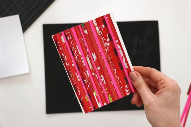 Cut down your old cards and wrapping paper into strips of varying widths. Use a glue stick to glue them onto the insert. Trim the excess.