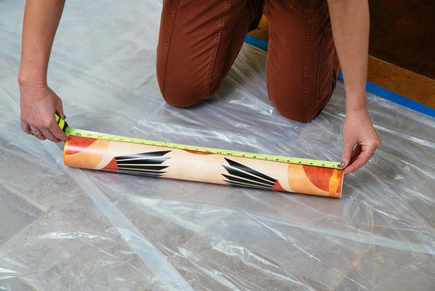 Measure your roll of wallpaper and subtract 2 inches.