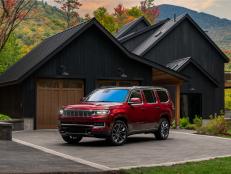 A premium SUV that combines leading edge technology and comfort, part of the exciting HGTV Dream Home 2022 prize package, sits in front of the home’s coordinating detached A-frame garage.