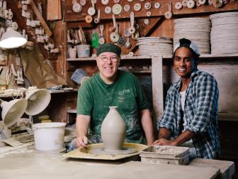 Two Men Smile To Camera in Pottery Studio Beside Tools, Pottery Wheel