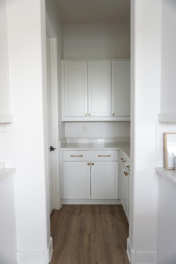 This pantry's before shot shows how plain and simple the space is. The white cabinets, white walls and white trim are clean, but lack vibrancy that the space needs.